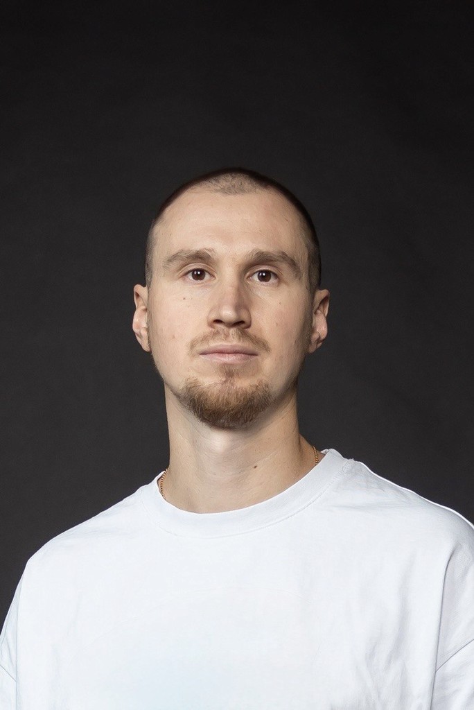 a man in a suit standing with his arms crossed